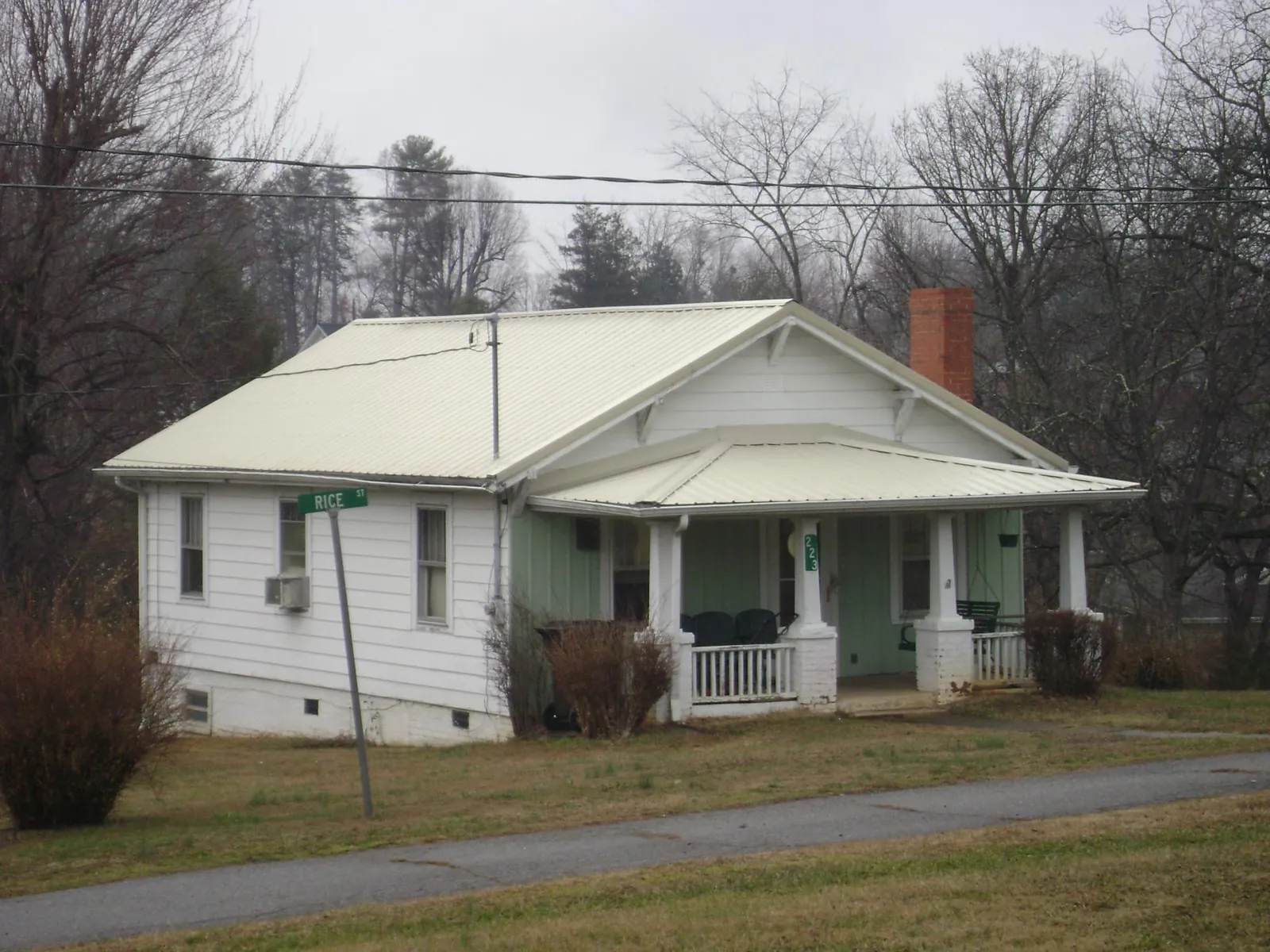 White metal roof on a craftsman bungalow at a street corner in White Earth